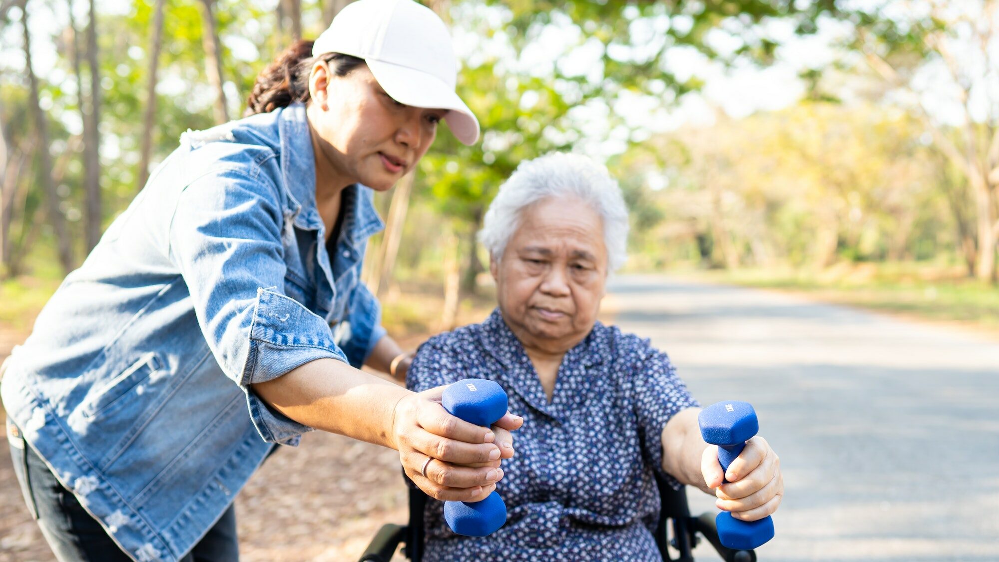 Asian senior or elderly old lady woman exercise with dumbbell in park.